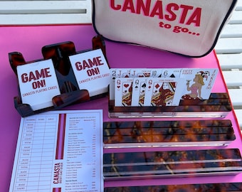 Canasta : tortoise spinner, 2 decks cards (with point value),  4 card racks, scoring pad all in canvas, “Canasta to go” bag