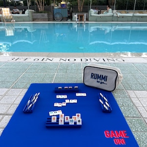 Mini Rummi Kub travel set . Canvas bag, 160 Rummi kub game tiles and 4 wooden racks all in our sturdy and chic Rummi to go bag.