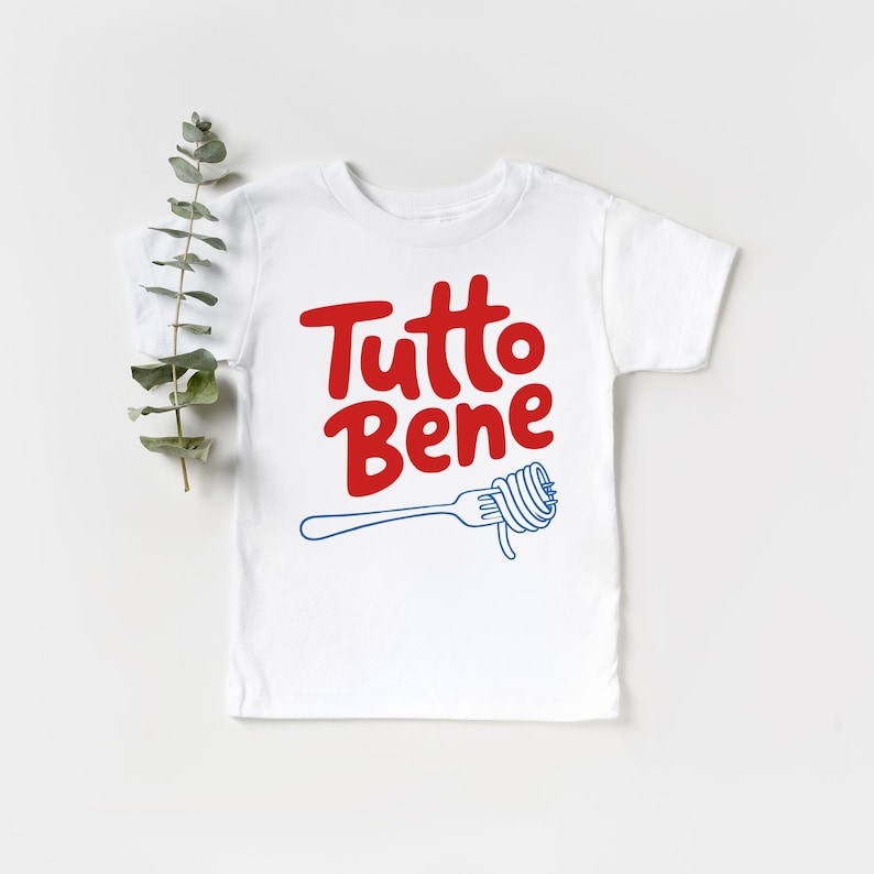 A white t-shirt with the text "Tutto Bene" printed on it, along with a graphic of a fork.