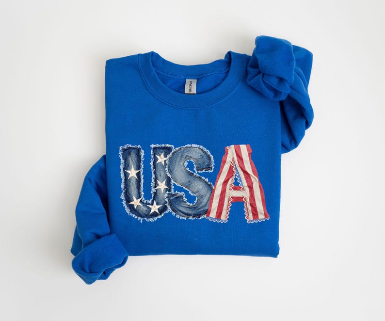 A blue sweatshirt with the word "USA" printed on it, featuring the American flag design.
