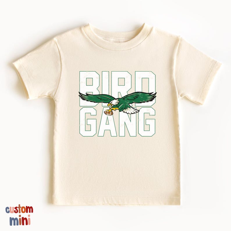 a white t - shirt with an eagle on it