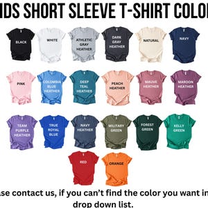 a collection of short sleeve t-shirt colors, including black, white, gray, natural, navy, pink, blue, deep blue, peach, maroon, navy, pink, true blue, navy, forest green, green, red, orange, and yellow.
