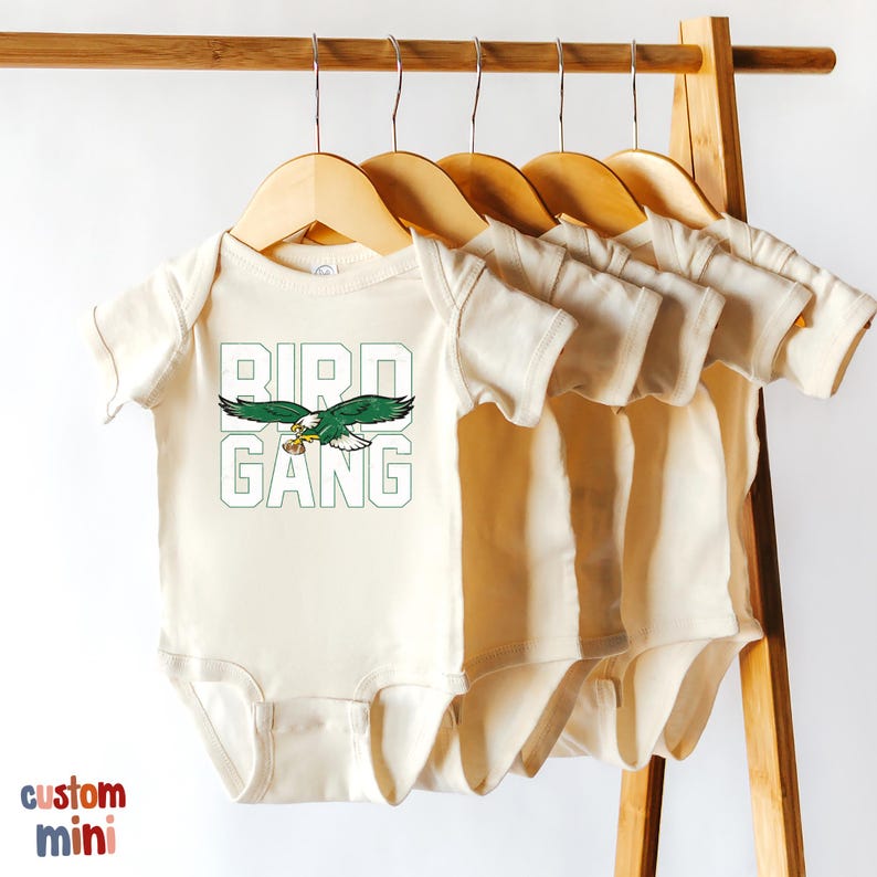 a baby's bodysuit hanging on a clothes rack
