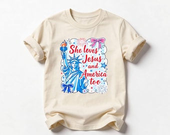 She Loves Jesus And America Too Shirt Christian Patriotic Kids Tee Statue Of Liberty Top Coquette Bow 4th Of July Independence Day T-Shirt