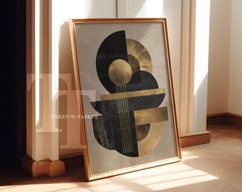 May include: A framed abstract art print featuring geometric shapes in black and gold against a neutral background. The artwork includes circles, rectangles, and lines, creating a modern, art deco style. The frame is a warm gold color, and the print leans against a wall.