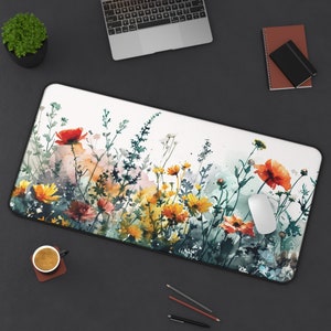 May include: A watercolour painting of a floral arrangement with orange, yellow, and red flowers on a white background. The flowers are surrounded by green leaves and stems.