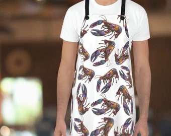 May include: A white apron with a colorful lobster pattern. The apron has adjustable straps and a button closure.