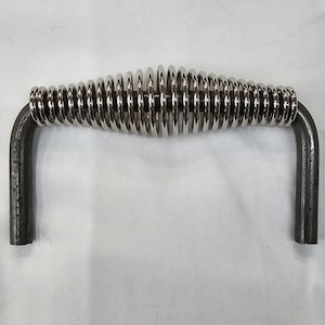 Puede incluir: Una manija de metal plateado con resorte con dos bucles de metal negro en cada extremo. La manija está diseñada para abrir cajones o puertas.