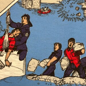 May include: A comic-style illustration depicts a flood rescue scene. A person in a red shirt is being pulled from the water by a rescuer in a blue uniform. Other figures are shown carrying sandbags. The background shows flooded buildings and a rescue boat.