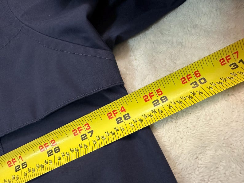 May include: A handmade wooden sign with the word "Welcome" in a whimsical font. The sign is painted white with a distressed finish, and features a floral design in pinks and greens. It measures approximately 30 cm wide.