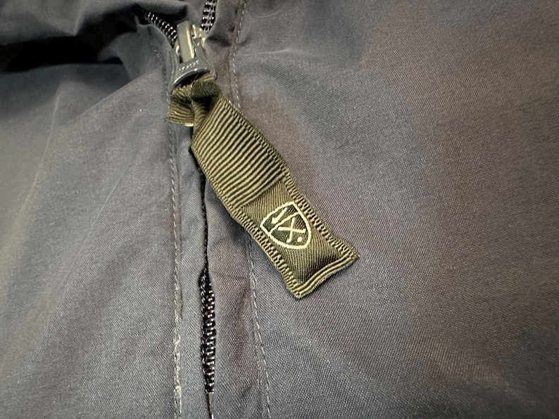 May include: A white ceramic mug with a black handle and the text "But First, Coffee" in a bold, black font. The mug is on a white surface.