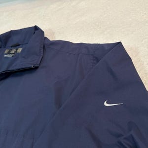 May include: A set of three ceramic mugs with a speckled, matte finish in cream, light grey, and dark grey. Each mug has a simple, minimalist design and a rounded handle.