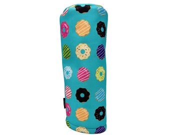 May include: A turquoise blue golf club head cover with a donut pattern. The donuts are various colours with sprinkles and frosting.