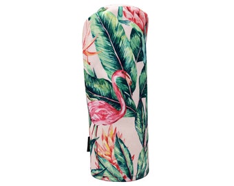 May include: A pink and green golf club head cover featuring a flamingo and tropical leaf design.