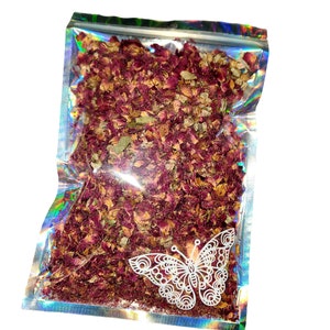 May include: A clear resealable bag filled with dried rose petals and leaves. The bag has a holographic iridescent finish and a white butterfly design.