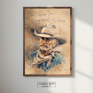 May include: Framed art print featuring a portrait of a cowboy wearing a hat and scarf. The artwork has a vintage aesthetic with a brown and beige color palette. The text "It ain't dying I'm talking about, it's living" is written at the top.