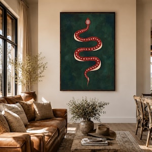 May include: A vertical rectangular wall art piece featuring a stylised red snake with white circular patterns along its body, set against a dark forest green textured background, framed in a thin dark brown wooden border.