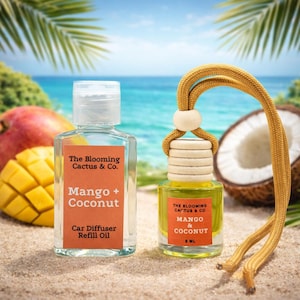 May include: Two car air fresheners with "Mango + Coconut" labels, one a refill oil bottle and the other a hanging diffuser. The background features a beach scene with a mango, coconut, and palm leaves.