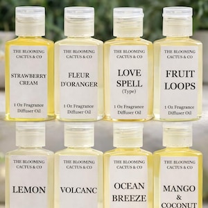 May include: Nine small, clear bottles of fragrance diffuser oil with white labels and clear caps. The labels read "The Blooming Cactus & Co" and list scents like Strawberry Cream, Fruit Loops, and Mango & Coconut. Each bottle contains 1 oz of oil.