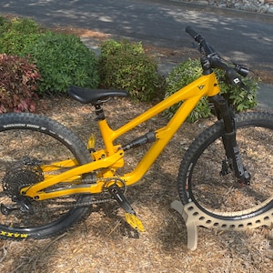 Birch plywood bike stand with a sleek, curved design. This minimalist stand securely supports your bike, blending function with style – perfect for homes, garages, or shops. Durable, modern, and eye-catching.