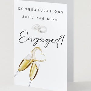 Elegante biglietto di auguri per il fidanzamento con champagne e anelli / Auguri di matrimonio per una coppia di novelli fidanzati