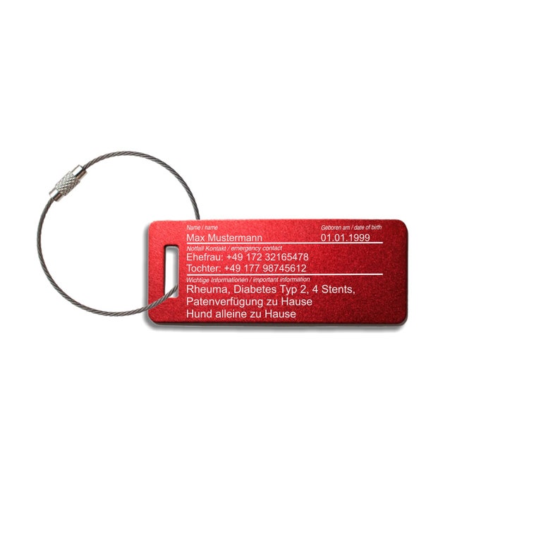 May include: Red metal luggage tag with a silver chain. The tag has the text "Max Mustermann" and contact information, including phone numbers and medical information. The tag also includes the text "Geboren am/date of birth 01.01.1999".