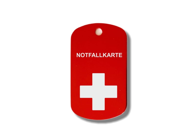 May include: Red metal tag with a white Swiss cross and the text "NOTFALLKARTE" in white.