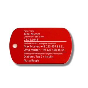 May include: Red rectangular tag with white text. The tag includes the name Maxi Muster, date of birth 22.04.1948, emergency contact information, and important information about diabetes type 2, insulin, and nut allergy.