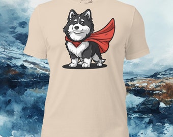 May include: A beige t-shirt featuring a cartoon image of a black and white dog wearing a red cape. The dog is smiling and has a red diamond on its chest. The text "Lapphund Designs" is printed on the shirt.
