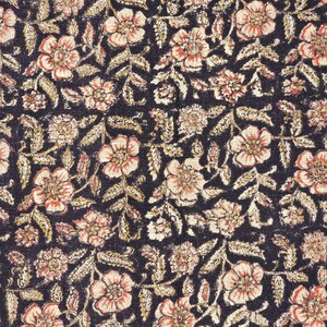May include: Close-up of a fabric with a repeating floral pattern. The design features peach-coloured flowers with dark centres and light beige leaves on a dark navy blue background. The pattern is dense and detailed.