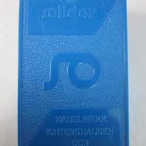 May include: A blue plastic box with the text "solido" and "Nadelwerk Ichtershausen DDR" printed on it.