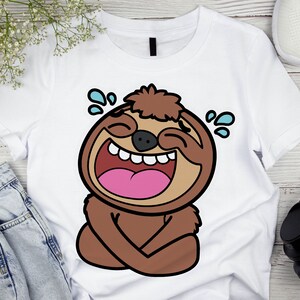 May include: A white t-shirt with a cartoon illustration of a brown sloth laughing with tears in its eyes.