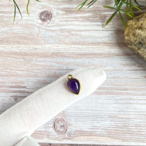 Small drop-shaped brass pendant with gemstone, charm with two eyelets for macrame