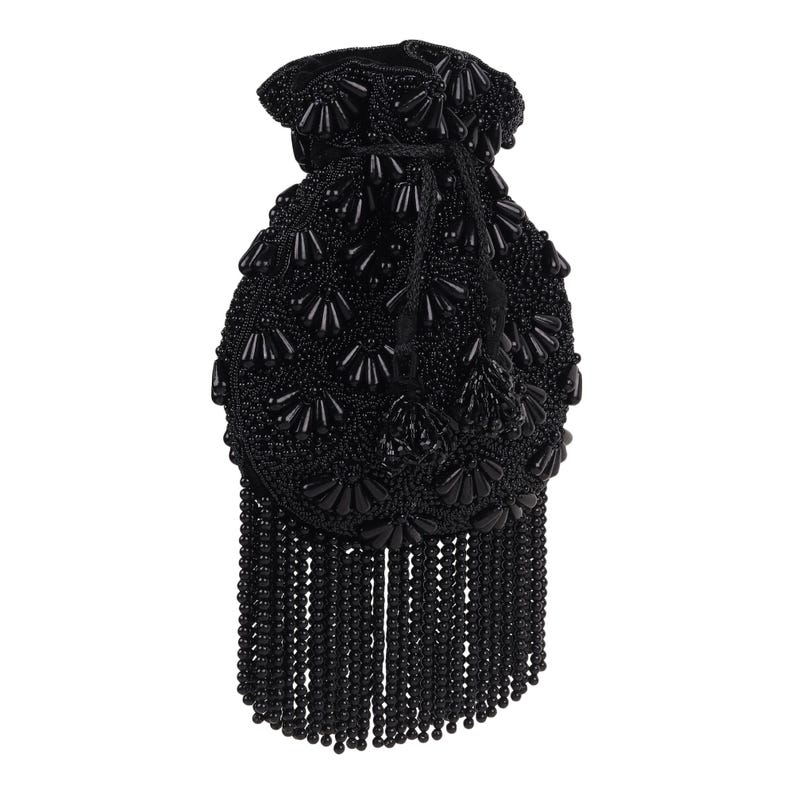 May include: A black beaded drawstring bag with a tassel fringe. The bag is covered in small, round beads and larger, decorative beads. The fringe hangs from the bottom of the bag.