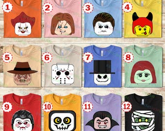 May include: A collection of twelve colorful t-shirts, each featuring a graphic design of a horror movie character in a Lego-style block head. The shirts are in various colors, including orange, pink, blue, yellow, tan, red, and black.