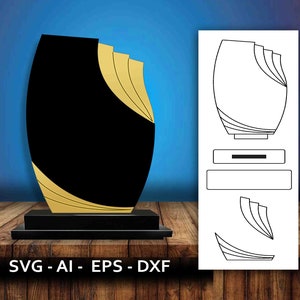 Puede incluir: Un trofeo negro y dorado con una base y un diseño único. El trofeo está hecho de metal y tiene un aspecto moderno. El trofeo es perfecto para una ceremonia de entrega de premios o una ocasión especial.