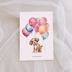 May include: A watercolor illustration of a brown and white puppy holding onto a bunch of colorful balloons. The balloons are pink, blue, yellow, and orange. The puppy is sitting on the ground and looking up at the balloons. The text "WondersArtist" is at the bottom of the image.