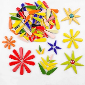 May include: Assortment of colourful ceramic flower shapes and teardrop-shaped tiles. The tiles are in various colours, including red, yellow, green, blue, and orange. The flower shapes are in various sizes and colours.