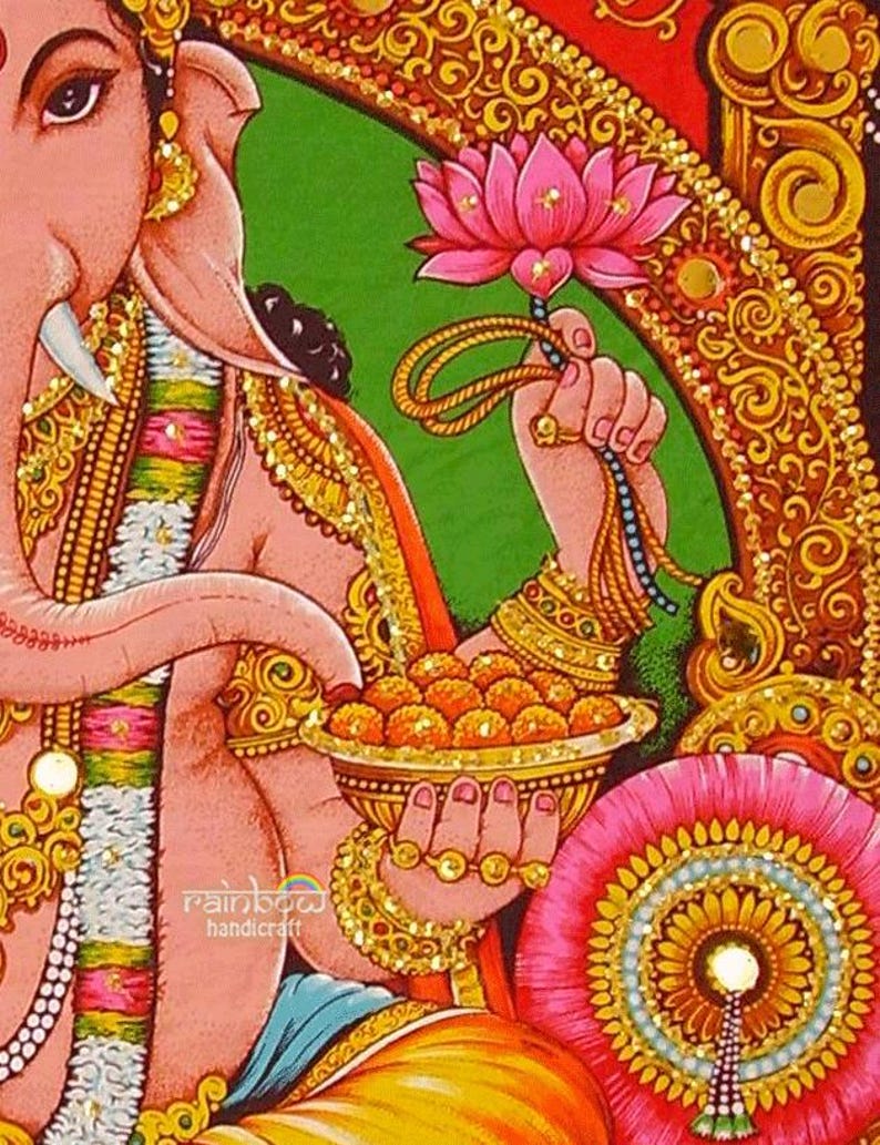 God ganesha holds lotus in one hand and a bowl of sweets, which he eats with his trunk