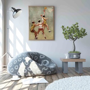 May include: A vintage illustration of three basketball players in action. The players are wearing yellow and red jerseys with numbers on the back. The player in the center is jumping up to shoot the ball. The illustration is framed and hanging on a white wall.