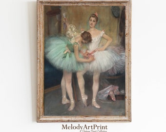 May include: A framed vintage print depicts three ballerinas in a dressing room. One ballerina in a white tutu is being helped by another in a green tutu. The third ballerina stands in the background. The frame is a light, distressed wood.