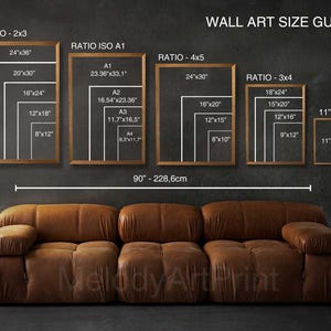 May include: Wall art size guide with framed examples. Displays various aspect ratios, including 2x3, ISO A1, 4x5, and 3x4, with corresponding dimensions in inches. A brown leather sofa is in the foreground, and the text "WALL ART SIZE GUIDE" is at the top.