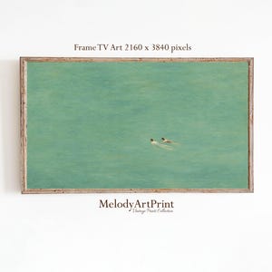 May include: A framed art print for a TV screen featuring a serene turquoise water scene with two figures swimming. The artwork is set in a wooden frame. The text "Frame TV Art 2160 x 3840 pixels" is at the top, and "Melody ArtPrint Vintage Prints Collection" is at the bottom.