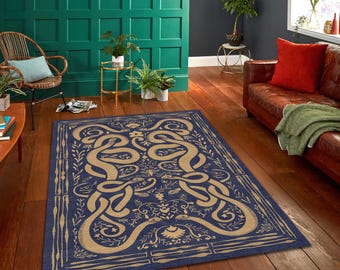 May include: A rectangular rug with a navy blue background and a beige, intertwined snake design. The rug features floral and leaf motifs, with a border of vertical lines and leaves. The rug is placed on a hardwood floor.
