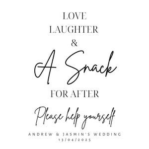 May include: A white sign with black script that reads "LOVE LAUGHTER & A Snack FOR AFTER Please help yourself." Below the text is "ANDREW & JASMIN'S WEDDING 13/04/2025."