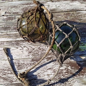 Lot of 2 old fishing net floats.