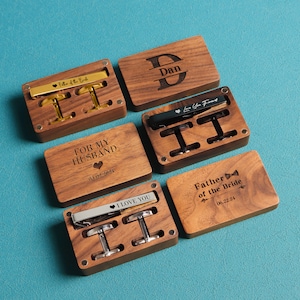 May include: Five wooden boxes with engraved messages and dates. Each box contains a tie clip and cufflinks. The messages include "For My Husband", "Father of the Bride", "Dan", "Love You Forever", and "Best Man".