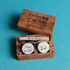May include: Wooden box with a tie clip and cufflinks. The box is engraved with the text "Father of the Bride" and the date "12th September 2024". The cufflinks are engraved with the text "I loved you first" and "Dad".