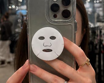 フェイスマスク型スマホグリップ、ユニークなiPhoneアクセサリー