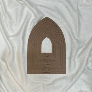 May include: A set of eight brown arch-shaped stencils with measurements in inches. The stencils are arranged in a rainbow pattern, with the largest stencil at the bottom and the smallest stencil at the top. The stencils are made of a sturdy material and are perfect for crafting projects.